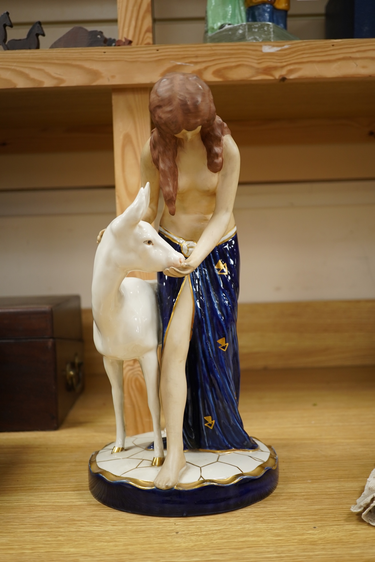 A Royal Dux Art Deco porcelain group of girl with a deer 37.5cm high